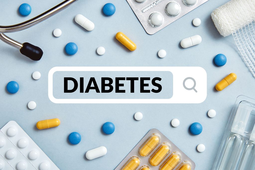 the word diabetes in a search bar with scattered medicine around