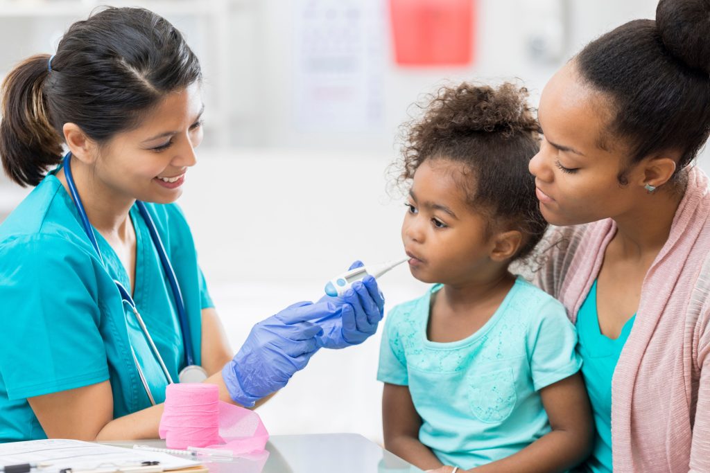 mother taking her child to get her temperature checked by nurse