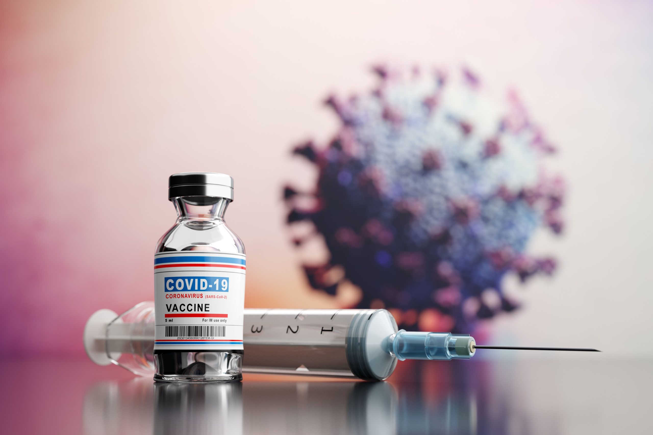 vaccine and syringe placed on surface with a germ in the background